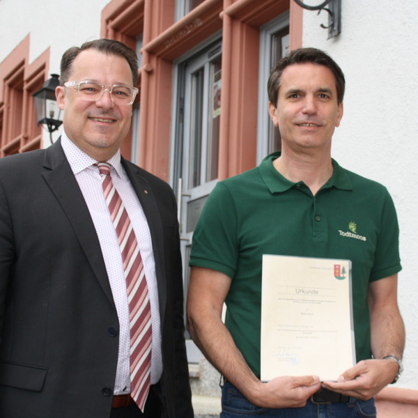 B�rgermeister Marcel Schneider �berreicht Markus Bolz die Urkunde